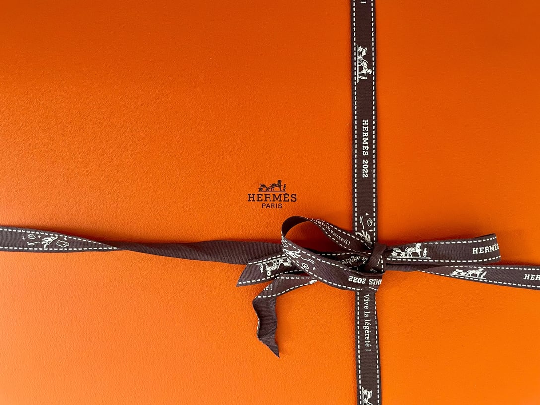 Up close image of an orange Hermès box.
