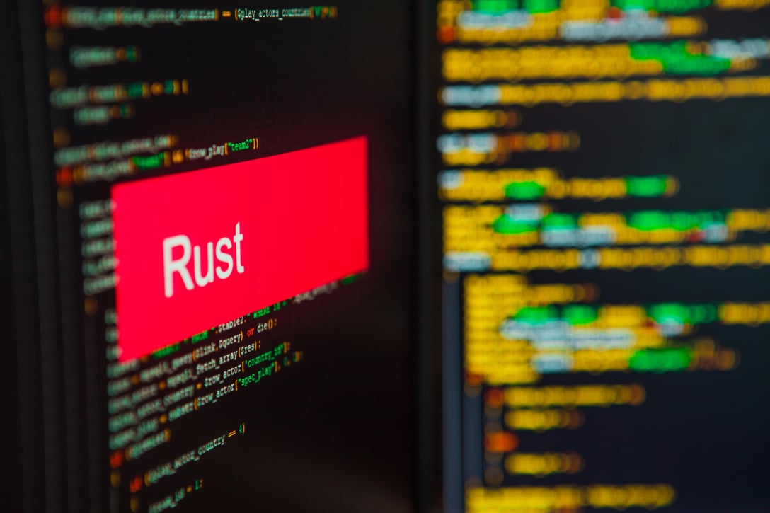A picture of two computer screens with Rust development language on them.